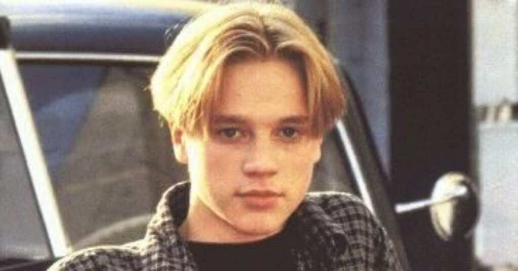 90s heartthrob mod cut with a clean middle part and curtain fringe.