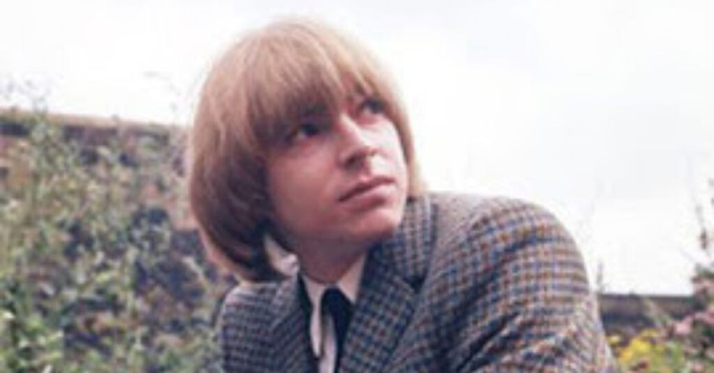 Alt Text: Classic 60s mod cut for men featuring a heavy forward fringe and long sideburns, one of the best mod haircuts for men.