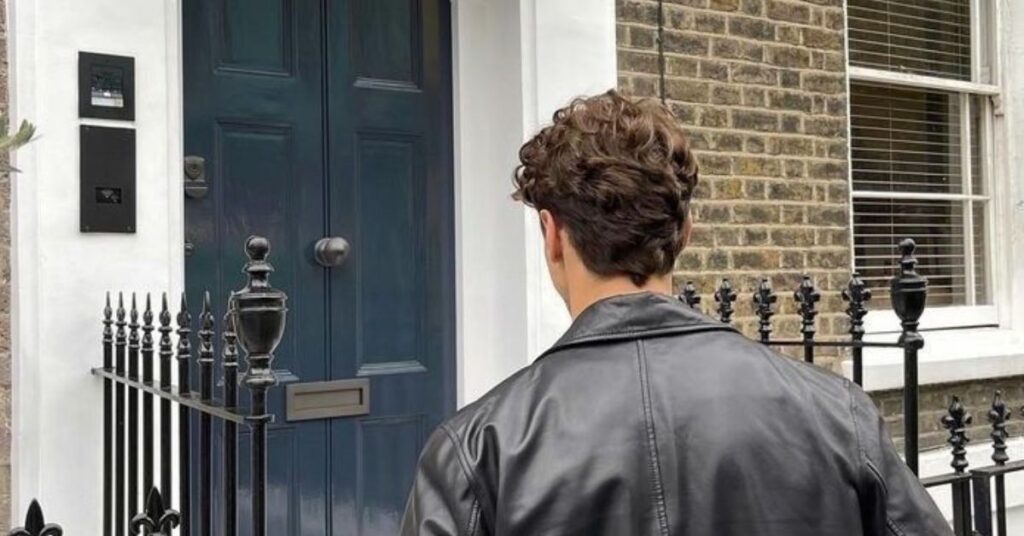 Curly mop top hair men's with defined messy curls and high volume