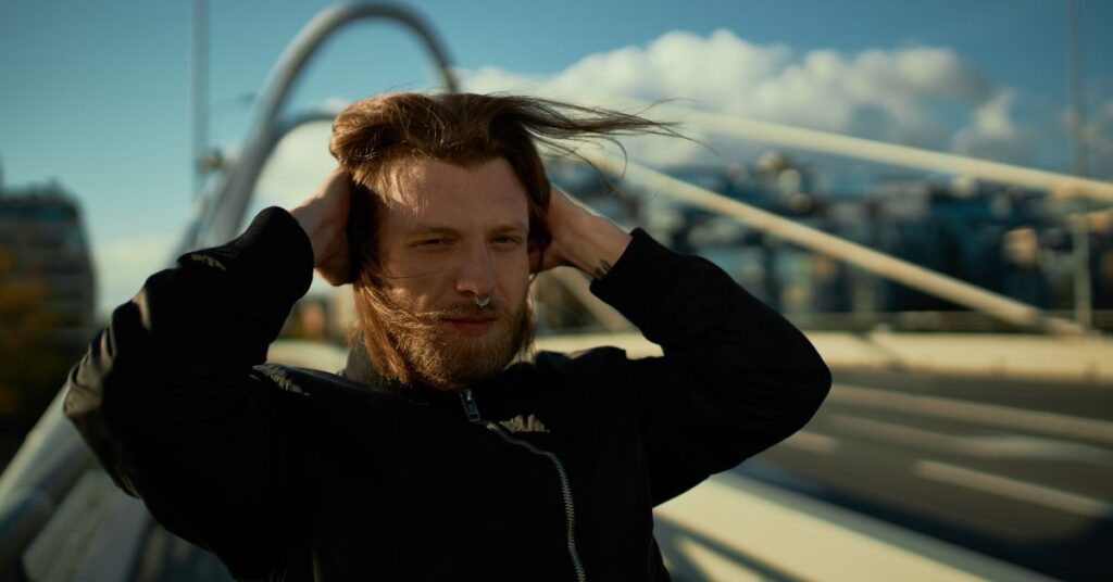 Forward-brushed wave layered haircut for men to increase hair density