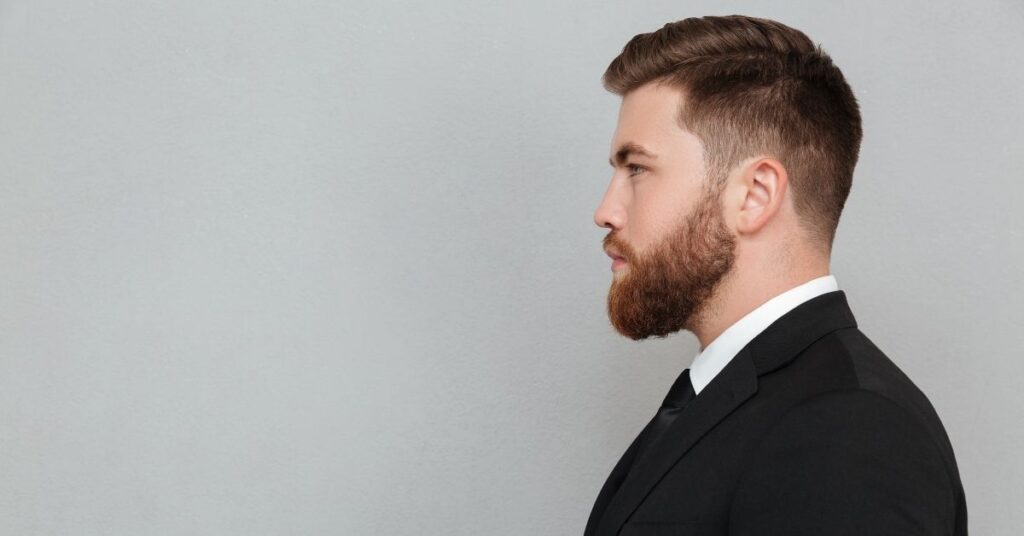 High skin fade slick back hairstyle for men with sharp, clean sides