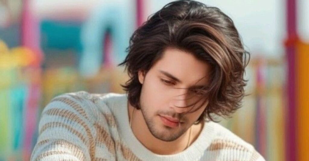 Men's layered curtain bangs with middle part and soft face-framing texture