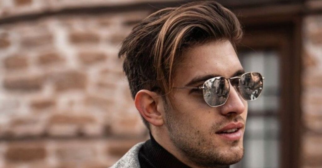 Layered slick back haircut for men with high-shine luxury finish and textured flow