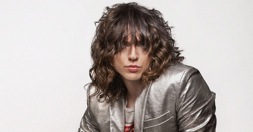 Long shaggy mod cut with shoulder-length layers and messy texture.