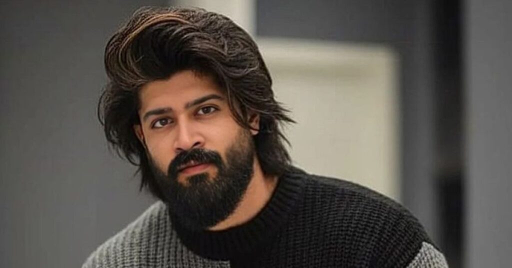 Men's long wavy hairstyle with shoulder-length layers and effortless messy flow