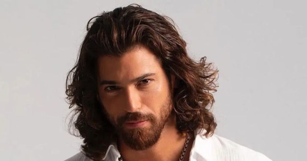 Messy braided bun hair men's with intricate loose braids and textured long hair