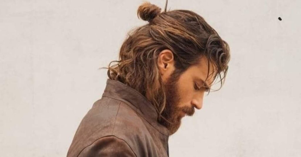 Messy man bun hair mens with relaxed tie-up and natural texture