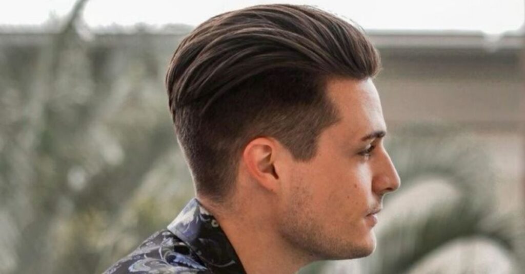 Messy “out of bed” slick back hairstyle for men with casual, textured look