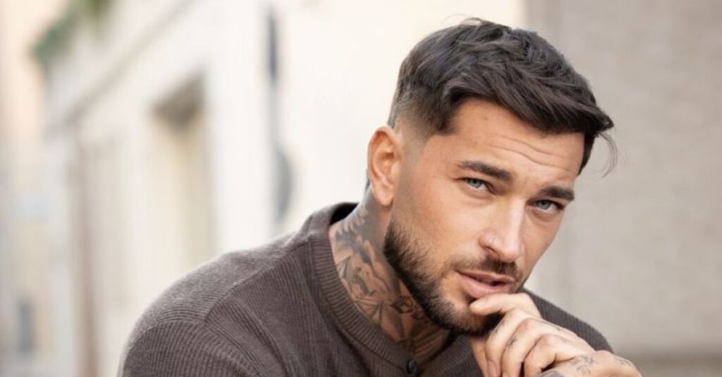 Textured fringe haircut with a clean taper fade and layered messy top