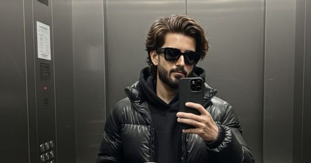 The iconic men's bro flow haircut with medium length layered hair and natural sweep.