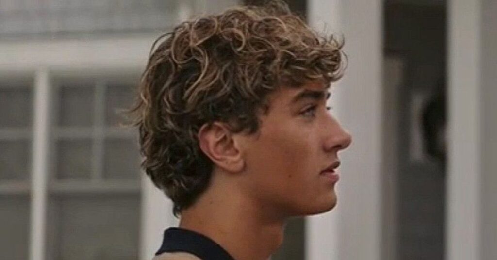 Men’s jellyfish cut featuring disconnected long bottom layers and a short shaggy bob-style top for a high-fashion artistic look.