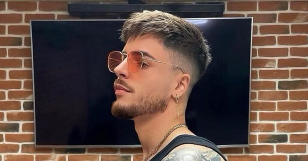 Men's long shaggy haircut with thick layers and textured movement for a relaxed look.