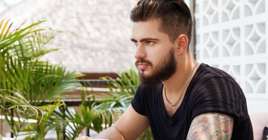 Mid-fade shaggy crop haircut for men featuring a textured forward-swept fringe and a clean taper on the sides.