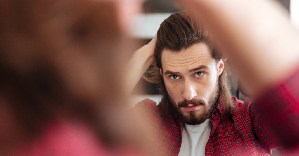 Modern bro flow haircut for men with swept-back layers and natural movement