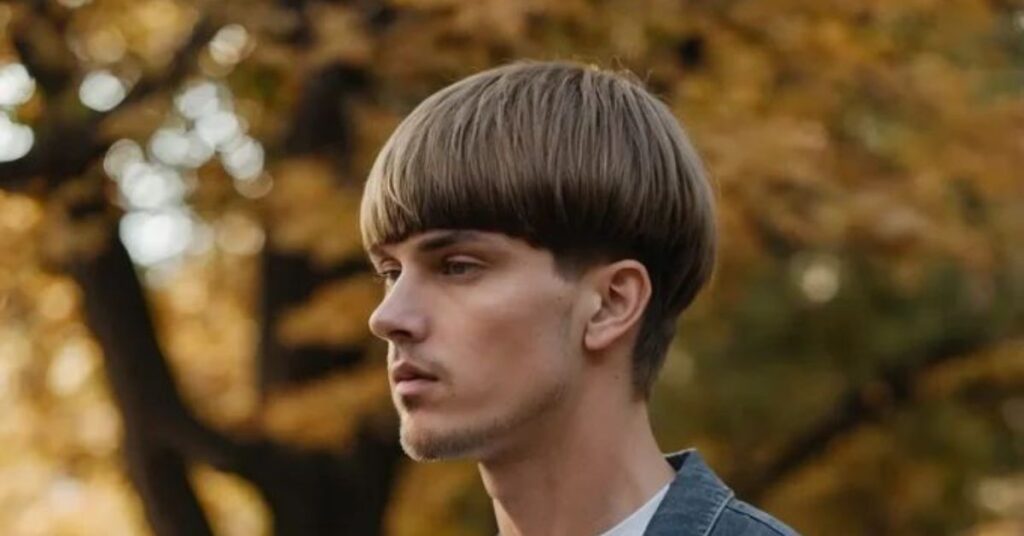 Modern men’s shaggy bowl cut featuring a blunt perimeter, heavy textured layers throughout the crown, and a messy fringe for a contemporary streetwear look.