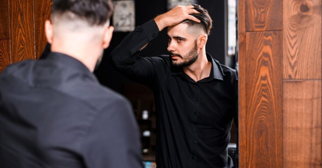 Slick back mullet hairstyle for men with textured layers and modern finish