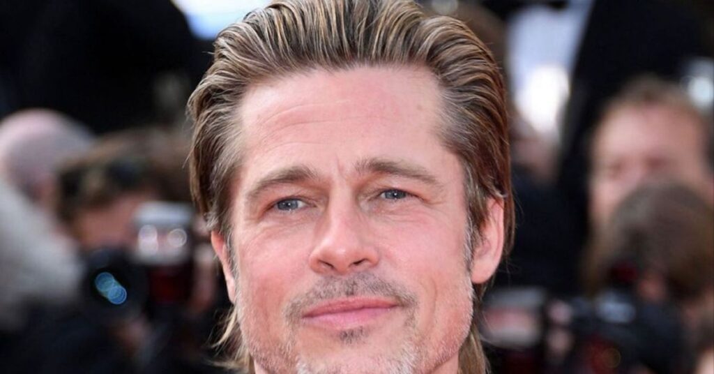 Surfer slick back hairstyle for men with relaxed, wavy hair and casual finish