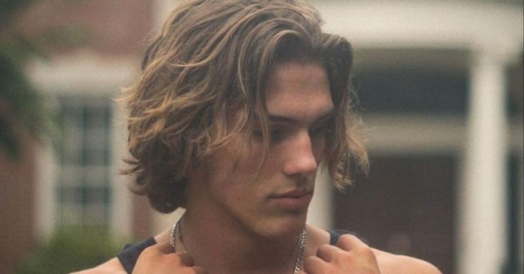 Thick hair weight-reduced slick hairstyle for men with smooth, controlled finish