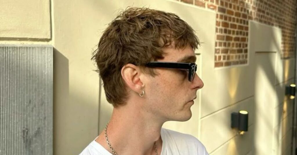 Layered mod haircut with textured depth and a shaggy fringe.