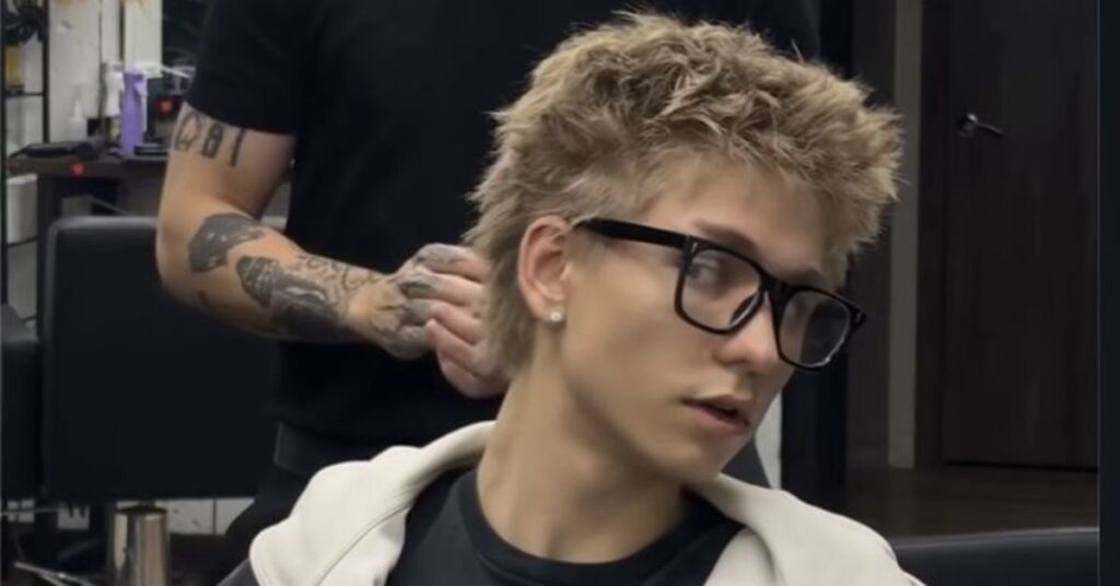 Short textured crop haircut with choppy layers on top and a sharp skin fade.