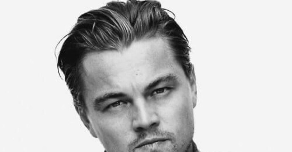 Polished slicked back haircut for men with tapered sides.