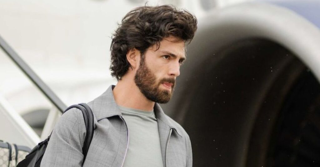 Men’s haircut with a long, natural flow at the back and neatly tapered sides.