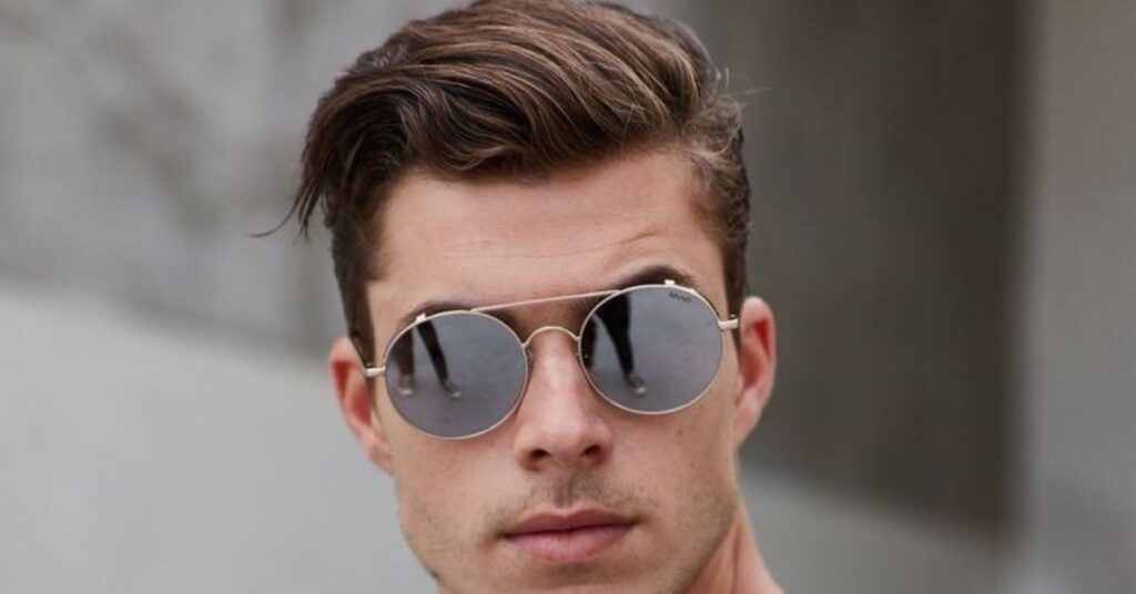 Professional tapered side part with a defined parting and short back.