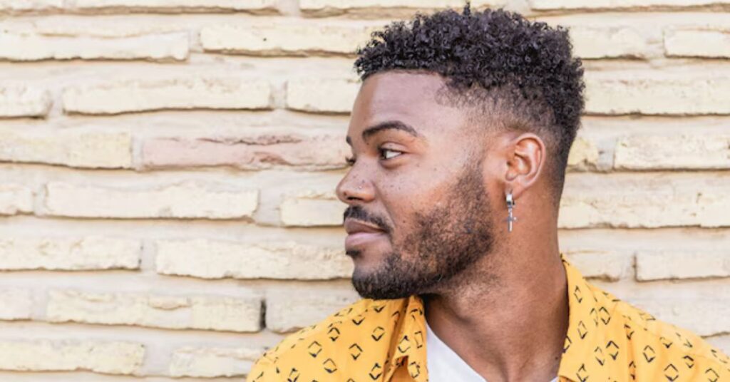 Traditional afro hair with soft tapered sides for a clean finish.