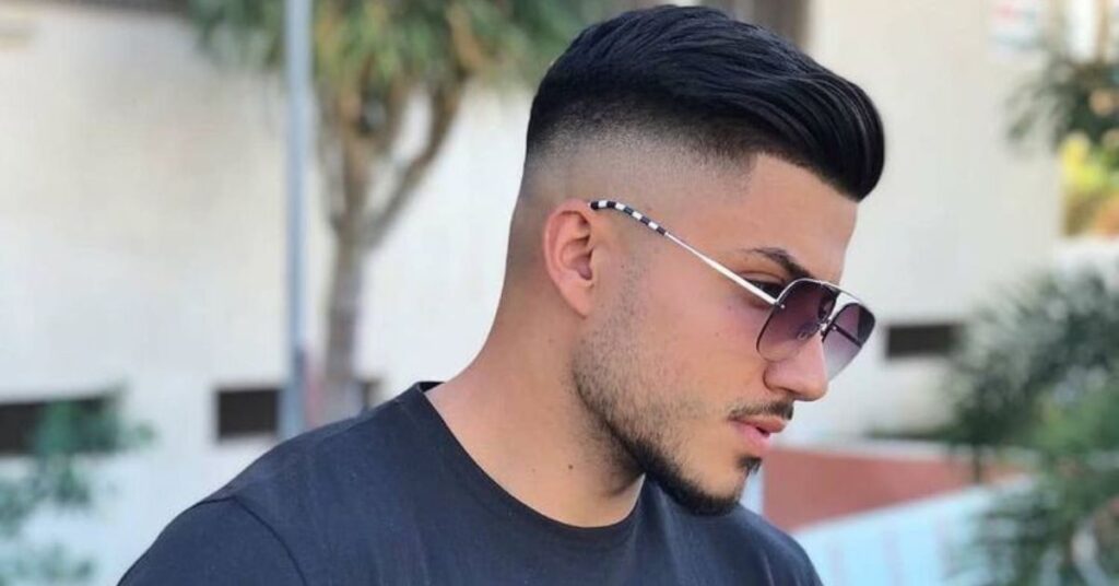 Smooth high shadow fade for dark hair with seamless blending.