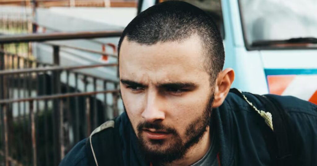Side view of a sharp high fade buzz cut for men with a clean hairline.