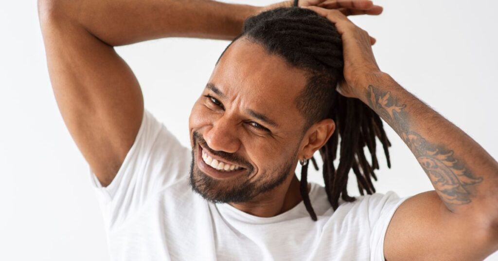 Long cascading locs with high shaved sides and back.