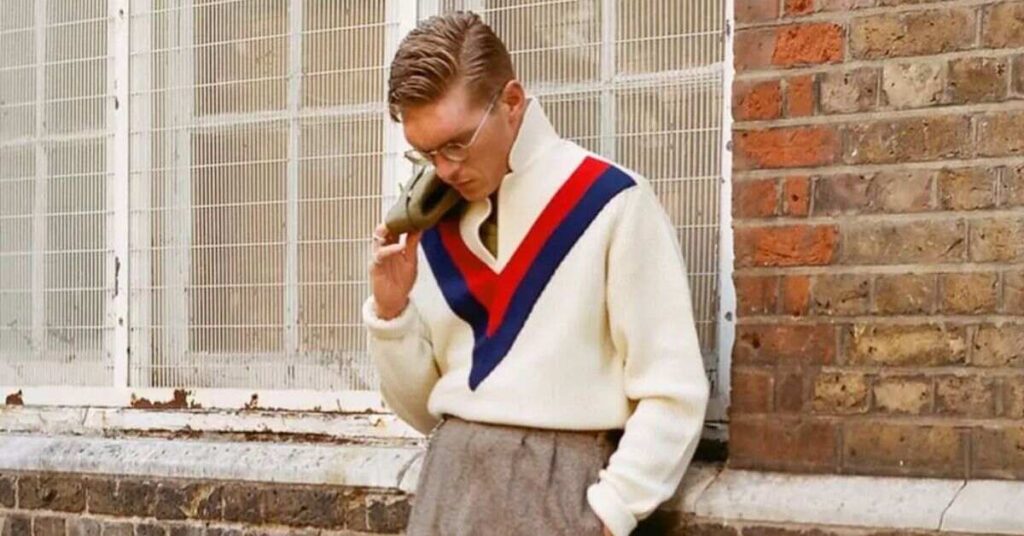 Close-up of a classic 60s mod haircut with thick eyebrow-length fringe and rounded sides covering ears.