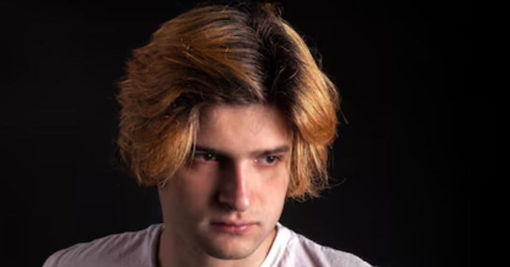 Choppy layered hair on top with a stylish drop fade.