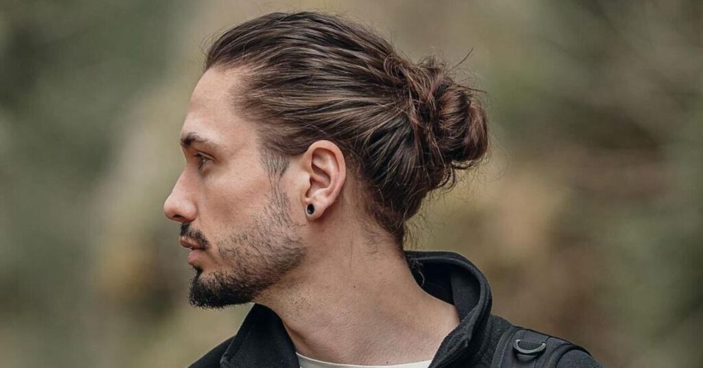 Samurai-style Man Bun with a high undercut Korean hairstyle cut for a sharp profile.
