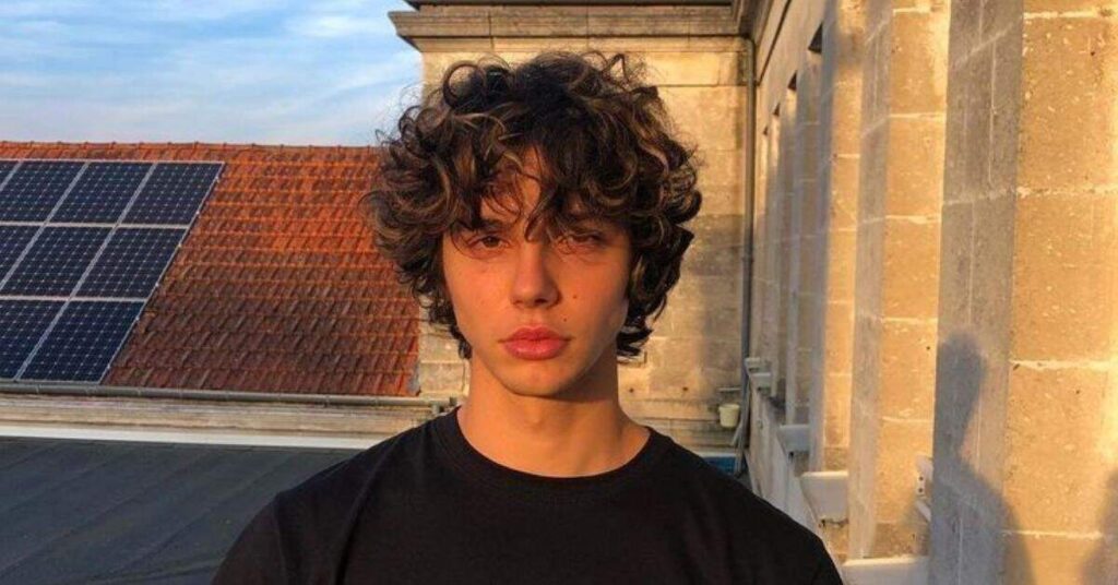 Permed mod hairstyle with added volume.