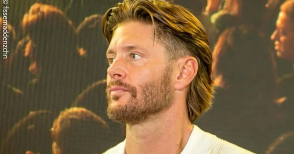 Refined modern mullet with tapered sides for men with straight hair.