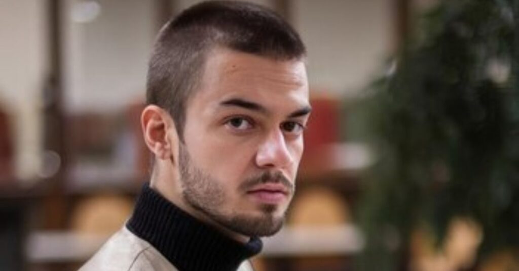 Professional high and tight fade haircut for a masculine profile.