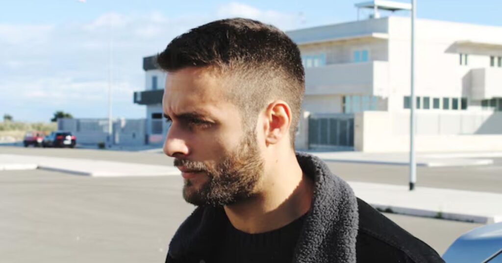 Modern mullet haircut with high skin fade and long hair in back.